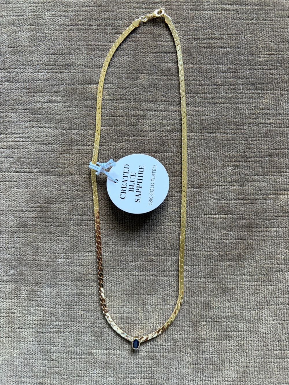 Gold necklace with sapphire gemstone pendant